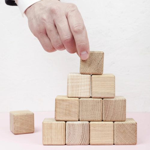 hand-creating-pyramid-from-wooden-cubes_result